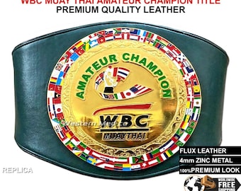May include: Green leather boxing championship belt with a gold metal plate featuring the text "WBC Muaythai Amateur Champion" and a graphic of a fighter. The belt is decorated with a ring of colorful flags.