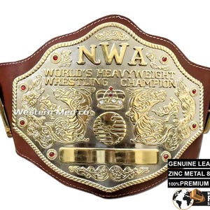 May include: A gold and brown wrestling championship belt with the text "NWA World's Heavyweight Wrestling Champion".