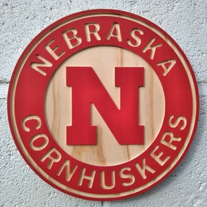 Nebraska Cornhuskers carved wood wall hanging sign (11&quot; round hybrid painted/natural grain)