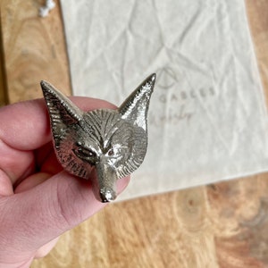 May include: Silver fox head bottle stopper. The fox has a detailed design with a textured fur pattern.