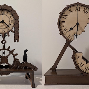 May include: Two brown wooden clock sculptures. One features a clock face with Roman numerals, a chain, and a gear. The other has a broken clock face design. Both have a small silhouette figure.