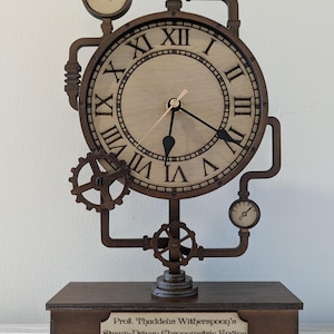 May include: A steampunk-style wooden clock with Roman numerals, gears, and gauges. The clock features the text "Prof. Thaddeus Witherspoon's Steam-Driven Chronometric Engine ~ Patented 1873~" on the base. The clock is brown and beige.