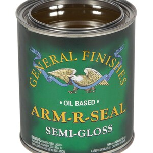 May include: A green can of General Finishes Arm-R-Seal Semi-Gloss oil-based wood finish. The can is labeled with the product name, brand, and size: 1 quart (946 ml).