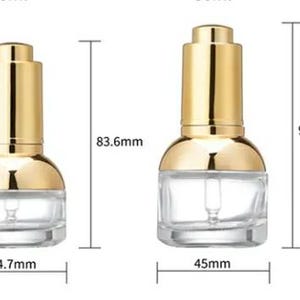 May include: Two clear glass dropper bottles with gold-coloured caps. The bottles are labelled with measurements: 83.6mm and 90.8mm in height, and 44.7mm and 45mm in width. The bottles are designed for cosmetic or skincare products.