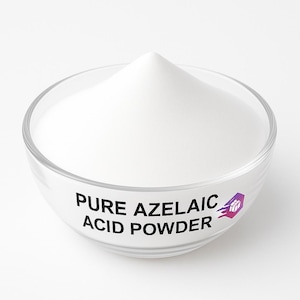 May include: A clear glass bowl filled with a large quantity of white powder. The bowl has a white label with the text "PURE AZELAIC ACID POWDER" in black. A purple and pink logo is on the right side of the label. The powder is piled high in the center.
