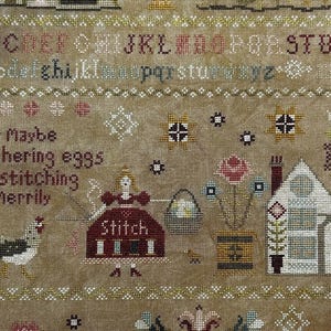 May include: Cross-stitch sampler with an alphabet, decorative borders, and charming illustrations. The design includes a house, flowers, a hen, and the word "Stitch." The text reads "or Maybe gathering eggs and stitching Merrily."