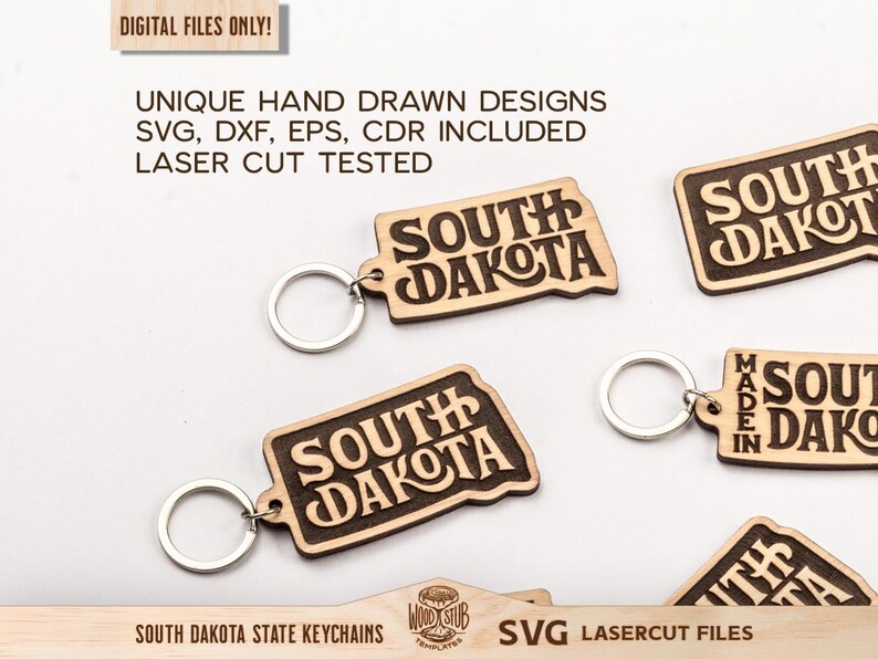 May include: Wooden keychains in the shape of South Dakota with the state name engraved. The keychains have a light brown color with dark brown engraved text. The image also includes the text "DIGITAL FILES ONLY!" and "SVG LASERCUT FILES".