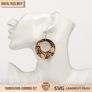 May include: Wooden hoop earrings with a pumpkin design. The earrings are brown and beige, with a laser-cut pumpkin and leaf pattern. The earrings are displayed on a white mannequin head. The text "DIGITAL FILES ONLY!" is in the top left corner.