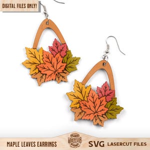 May include: A pair of dangle earrings featuring a light wood arch frame with a cluster of layered maple leaves in shades of yellow, orange, red, and green. The earrings include silver-toned metal hooks. Text in the image reads DIGITAL FILES ONLY, MAPLE LEAVES EARRINGS, and SVG LASERCUT FILES.