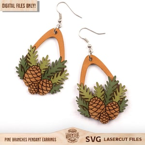 May include: A pair of teardrop-shaped wooden earrings featuring a cutout design with green pine branches and brown pinecones. The earrings have silver-toned metal hooks. Text on the image reads: DIGITAL FILES ONLY! PINE BRANCHES PENDANT EARRINGS.