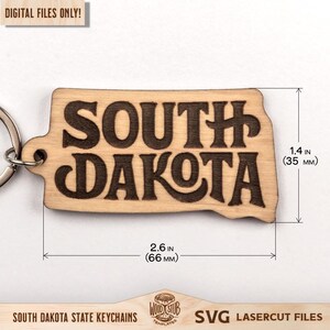 May include: A wooden South Dakota state keychain with the state's name engraved in a bold font. The keychain is 2.6 inches (66 mm) wide and 1.4 inches (35 mm) tall. The text "DIGITAL FILES ONLY!" is in the top left corner.