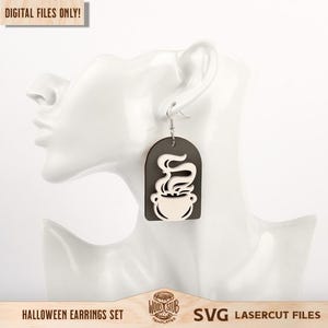 May include: A dangling earring featuring a dark gray arch-shaped base with a light-colored cutout of a steaming cauldron. The text "DIGITAL FILES ONLY!" appears in the top left corner, and the bottom text reads "HALLOWEEN EARRINGS SET SVG LASERCUT FILES".