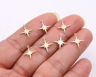 May include: Seven gold-toned metal star charms with a loop at the top for attaching to jewelry or crafts.