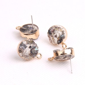 May include: Three pairs of gold-toned earring findings with a round, clear, and gray agate stone. The stones have a rough, textured surface.