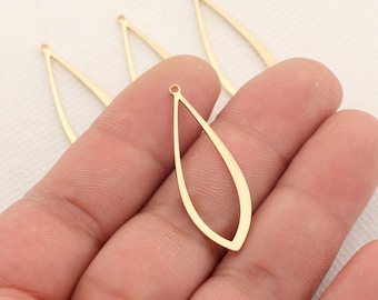 May include: Four gold-colored metal teardrop-shaped earring blanks with a hole at the top.