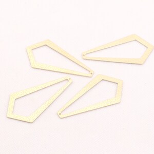 May include: Four gold-colored metal geometric shapes with a textured surface. The shapes are all similar in size and shape, but have slightly different angles. They are all open on one side.