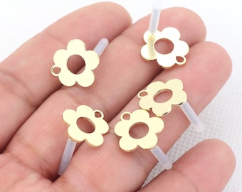 May include: Five gold-colored metal flower charms with a hole in the center. Each charm has a small clear plastic tube attached to the back.