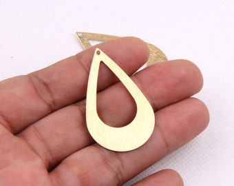 May include: Two gold-colored metal earring blanks in the shape of a teardrop with a hole at the top for attaching a hook or wire.