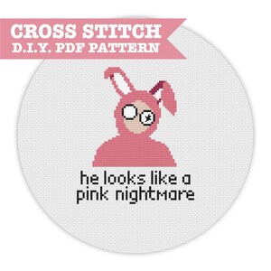 May include: A cross-stitch PDF pattern featuring a pink bunny costume with glasses and the phrase "he looks like a pink nightmare." The design is set against a white background with a cross-stitch texture. The text "CROSS STITCH D.I.Y. PDF PATTERN" is at the top.