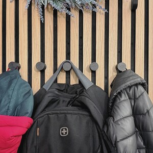 Knob coat hook for acoustic panels, black matte finish, no-drill and no-screw installation, perfect for organizing coats, bags, and accessories.