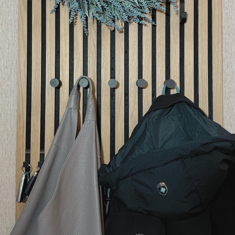 Knob coat hook for acoustic panels, black matte finish, no-drill and no-screw installation, perfect for organizing coats, bags, and accessories.