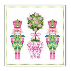 May include: Two pink and green nutcracker figurines stand on either side of a pink and white floral potted plant with a pink ribbon.