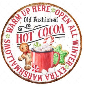 May include: A white round sign with red and black text that reads "Warm Up Here Open All Winter Extra Marshmallows Old Fashioned Hot Cocoa". The sign features a gingerbread man, a mug of hot cocoa with marshmallows, and a candy cane.