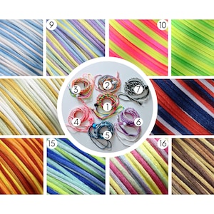 May include: A collection of colorful braided cord bracelets and samples of braided cord. The bracelets are in various colors, including pink, blue, green, and purple. The cord samples are in a variety of colors and patterns, including stripes and gradients.