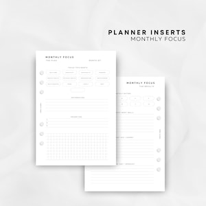 May include: White planner inserts with the text "MONTHLY FOCUS" and "PLANNER INSERTS MONTHLY FOCUS". The inserts include sections for planning, affirmations, priorities, and results. The design is minimalist and clean.