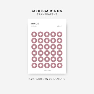 May include: A sheet of 36 medium-sized, transparent, velvet pink ring stickers. The stickers are arranged in a grid pattern. The text "RINGS MEDIUM VELVET" is printed at the top of the sheet. The text "AVAILABLE IN 20 COLORS" is printed at the bottom of the sheet.