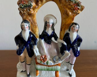Antique Staffordshire flat back three figures under an arbor