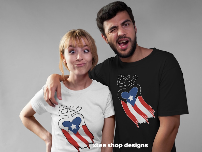 May include: Two people wearing t-shirts with a white outline of a stylized coqui frog holding a heart with a star inside. The heart is draped with a red, white, and blue Puerto Rican flag. The text "xtee shop designs" is at the bottom of the image.