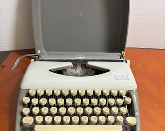 Vintage 60's Tippa 1 portable typewriter, with original travel case, two tone with cream and green/gray base