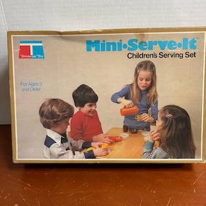 May include: A vintage Tupperware Toys "Mini-Serve-It" Children's Serving Set box. The box features a picture of four children playing with the set. The box is tan with blue and red text. The text on the box reads "For Ages 3 and Older."