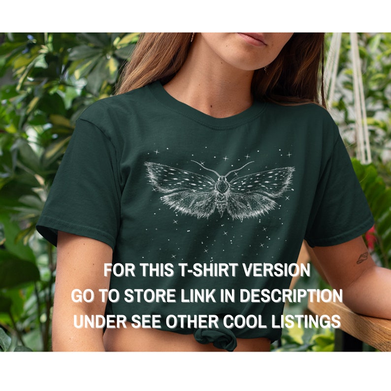 May include: A dark green t-shirt with a white moth graphic and a starry background. The text "FOR THIS T-SHIRT VERSION GO TO STORE LINK IN DESCRIPTION UNDER SEE OTHER COOL LISTINGS" is printed on the shirt.