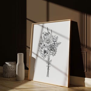 May include: A black and white line drawing of a bouquet of flowers in a wooden frame. The flowers include a poppy, a rose, and a snowdrop.