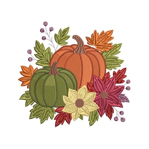 May include: An embroidered design featuring two pumpkins, one orange and one green, surrounded by fall foliage. The design includes orange and red leaves, burgundy flowers, and small purple berries, all on a white background.