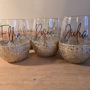 Personalized stemless wine glass with glitter-dipped bottom half, customized with any name for bridesmaids, birthdays, and special events.