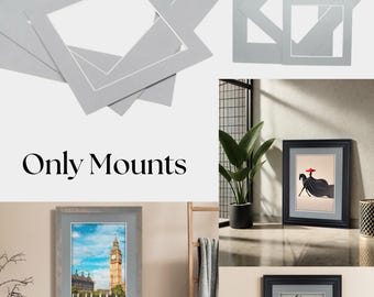 May include: A collection of gray picture frame mats in various shapes and sizes, with a white core. The image also shows framed artwork, including a Big Ben print and a black silhouette of a deer.