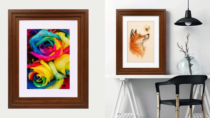 May include: Two dark brown wooden frames with white matting. The left frame displays a vibrant, multi-colored rainbow rose. The right frame features an illustration of an orange fox looking up at a small bee, presented in a room setting.