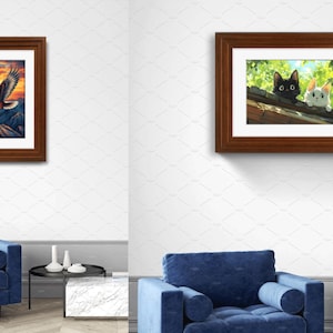 May include: Two framed wall art prints displayed in separate room settings. The left print features a bald eagle flying over mountains at sunset. The right print shows a black cat and a white cat peering over a roof edge amidst green foliage.