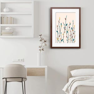 May include: A framed wall art print featuring a vertical botanical illustration of slender stems with small, multi-colored leaves in shades of teal, yellow, pink, and dark red against a pale cream background, enclosed in a dark brown wooden frame.