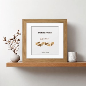 May include: A square wooden picture frame with a light oak finish and a white mount. The insert features the text Picture Frame, the OSUK logo, a geometric pattern of brown triangles, and the text MADE IN UK centred on the white background.