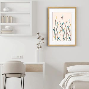 May include: A framed wall art print featuring a light cream background with a series of thin, vertical, dark green stems. The stems are adorned with small, scattered, oval-shaped leaves in shades of yellow, teal, pink, and dark red.