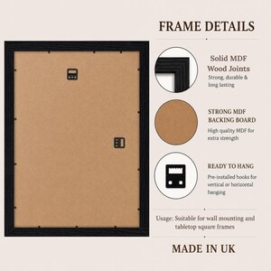 May include: A rectangular black picture frame shown from the back, featuring a brown MDF backing board with metal clips. Text labels describe frame details including solid MDF wood joints, a strong backing board, and pre-installed hanging hooks.