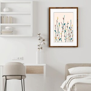 May include: A framed wall art print featuring a series of thin, vertical stems with small, colorful leaves in shades of teal, yellow, pink, and dark red against a light cream background, enclosed in a dark brown wooden frame.