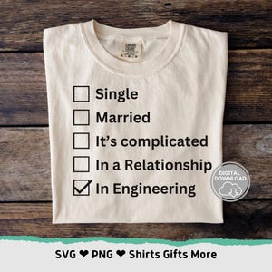 May include: A white t-shirt with a checklist of relationship statuses. The options are "Single", "Married", "It's complicated", "In a Relationship", and "In Engineering". The last option is checked.