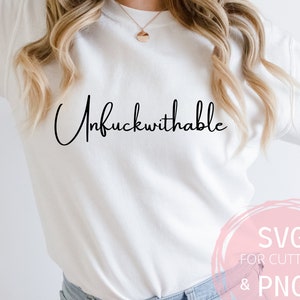 May include: White sweatshirt with the text "Unfuckwithable" written in black cursive script.