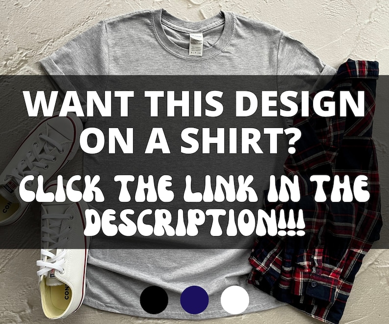 May include: A gray t-shirt with the text "WANT THIS DESIGN ON A SHIRT? CLICK THE LINK IN THE DESCRIPTION!!!" in white. The t-shirt is laid flat on a white surface with a pair of white sneakers and a plaid shirt on top of it. There are three color swatches below the text: black, navy blue, and white.