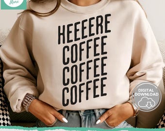 May include: A beige sweatshirt with the text "HEEEERE COFFEE COFFEE COFFEE" printed in black. The sweatshirt is being modeled by a person.